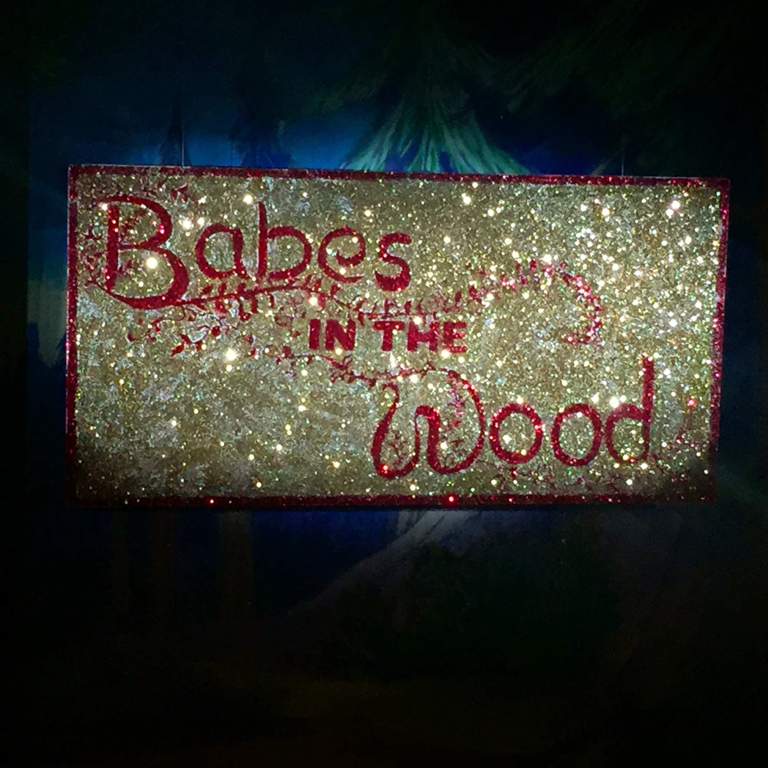 Glittery sign, reads babes in the wood